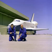 The first crew members for the Space Shuttle Approach and Landing Tests (ALT) are photographed at the Rockwell International Space Division's Orbiter Assembly Facility at Palmdale, California. The Shuttle Enterprise is Commanded by former Apollo 13 Lunar Module pilot, Fred Haise (left) with C. Gordon Fullerton as pilot. The Shuttle Orbiter Enterprise was named after the fictional Starship Enterprise from the popular 1960's television series, Star Trek. 